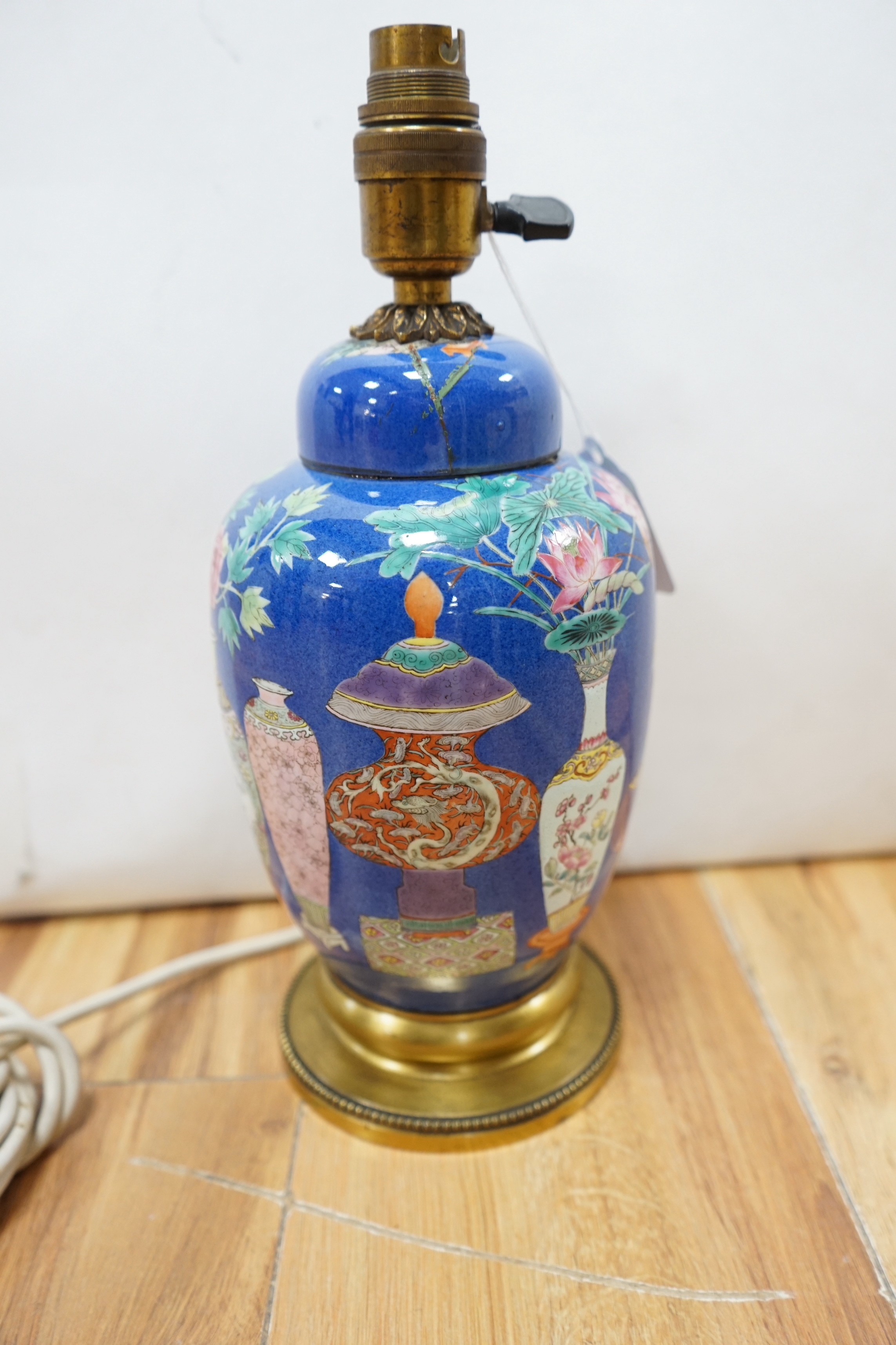 A late 19th century Chinese jar and cover with blue background and fine enamelled vases, jars, etc., later converted into a table lamp (cover broken in half and late glued to jar)